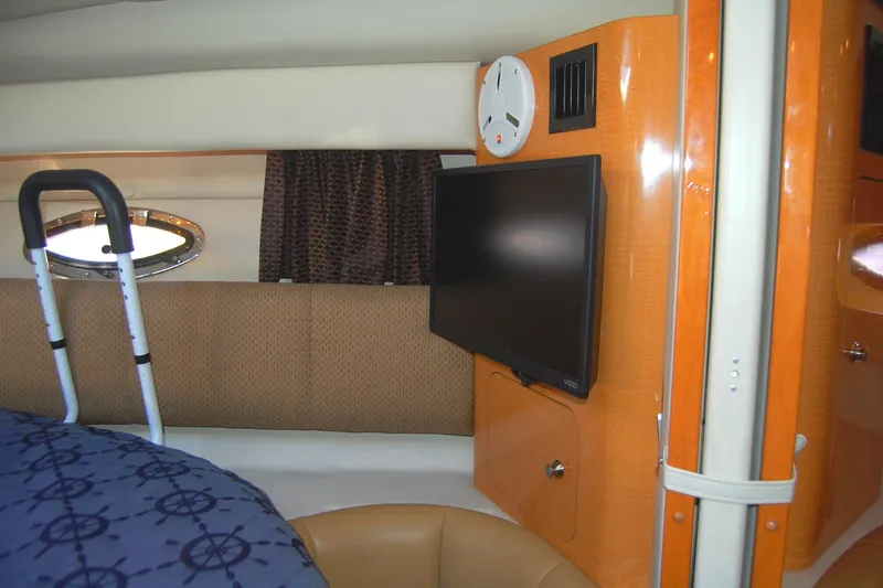 Slide: The Image of Interior of 2006 Chaparral Signature 350 yacht with TV, clock, and porthole window. - 30