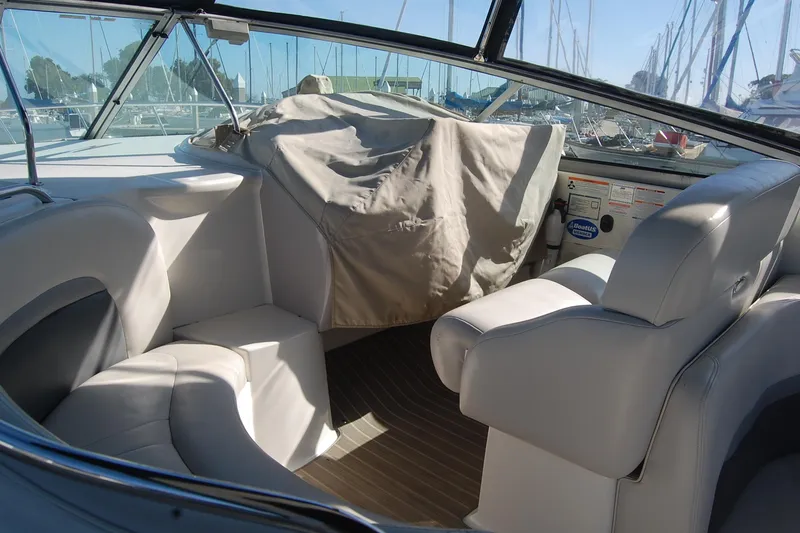 Slide: The Image of 2006 Chaparral Signature 350 boat interior with beige seating and covered dashboard. - 33