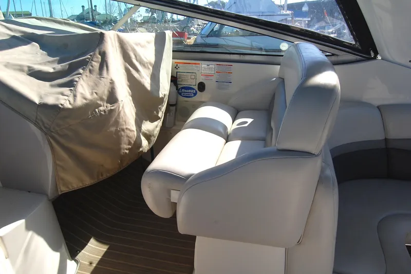 Slide: The Image of 2006 Chaparral Signature 350 boat interior with white seating and covered equipment. - 34