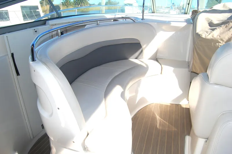 Slide: The Image of 2006 Chaparral Signature 350 boat interior with curved seating and wooden flooring. - 35