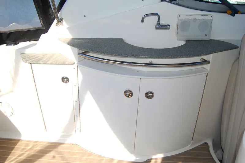 Slide: The Image of 2006 Chaparral Signature 350 boat interior with sink and storage cabinets. - 38