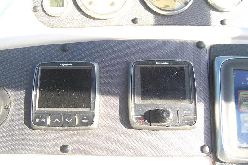 Slide: The Image of Control panel of a 2006 Chaparral Signature 350 boat with Raymarine displays. - 45