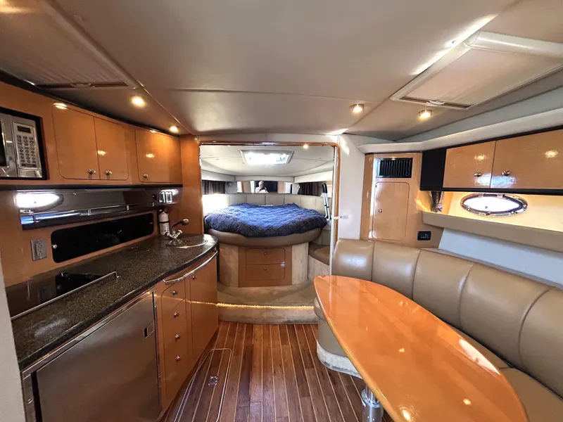 Slide: The Image of 2006 Chaparral Signature 350 yacht interior with kitchen, dining area, and sleeping quarters. - 5