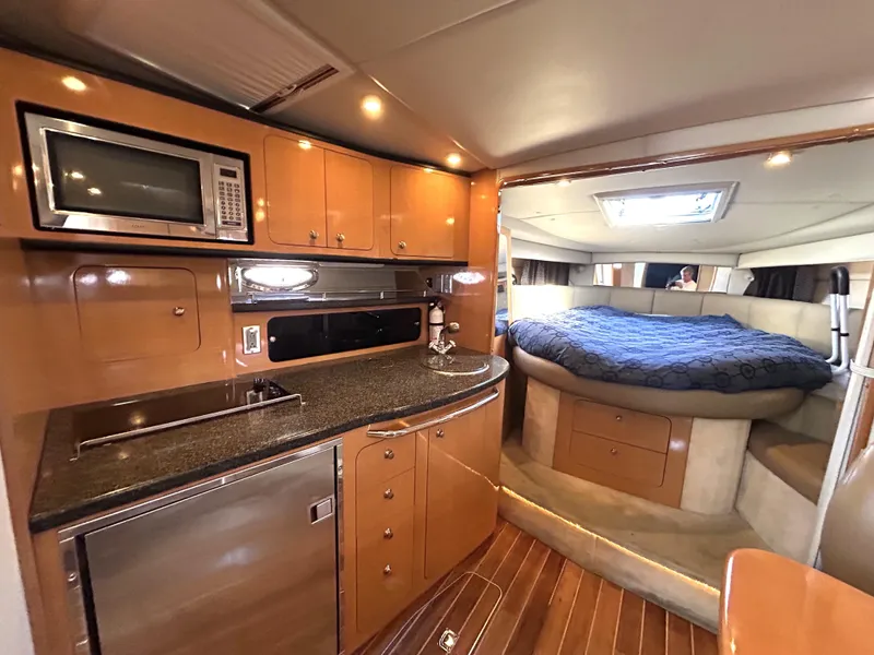 Slide: The Image of Interior of 2006 Chaparral Signature 350 yacht with kitchen and cozy sleeping area. - 9