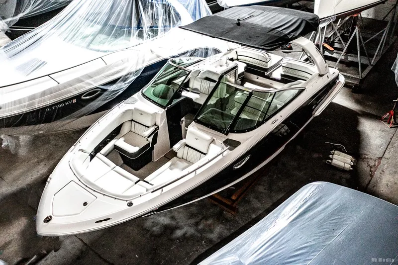 Slide: The Image of 2021 Regal 2800 Bowrider boat in storage, covered and protected. - 10