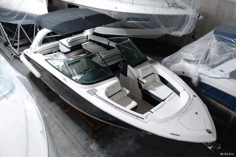 Slide: The Image of 2021 Regal 2800 Bowrider boat in storage, featuring sleek design and spacious seating. - 11