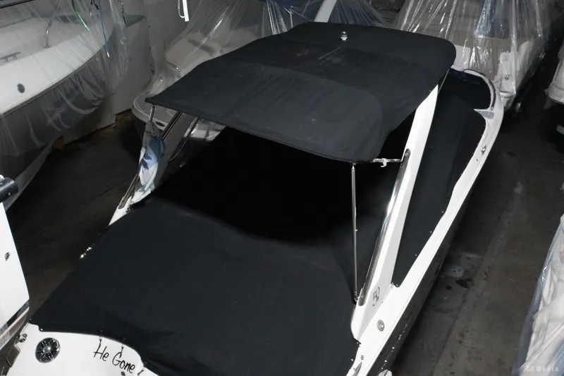 Slide: The Image of 2021 Regal 2800 Bowrider with black cover in storage. - 13