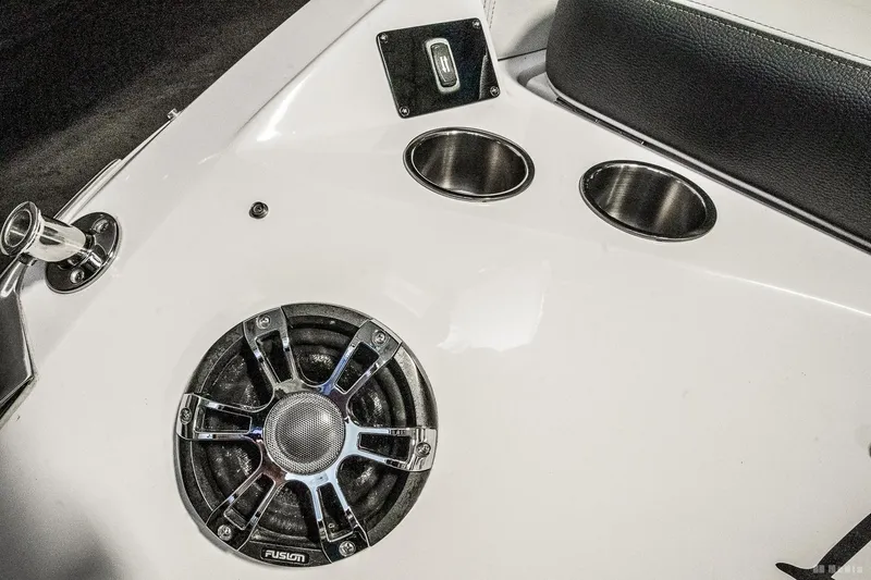 Slide: The Image of 2021 Regal 2800 Bowrider interior with speaker, cup holders, and USB port. - 17