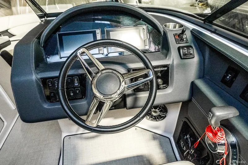 Slide: The Image of 2021 Regal 2800 Bowrider dashboard with modern controls and steering wheel. - 25