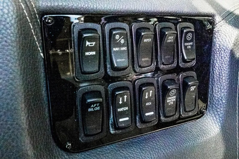 Slide: The Image of Control panel of 2021 Regal 2800 Bowrider boat with various switches. - 27