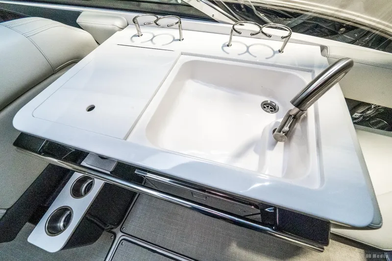 Slide: The Image of 2021 Regal 2800 Bowrider boat sink with faucet and cup holders. - 46