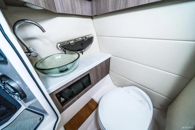 Slide: The Image of 2021 Regal 2800 Bowrider boat bathroom with modern sink and toilet. - 47