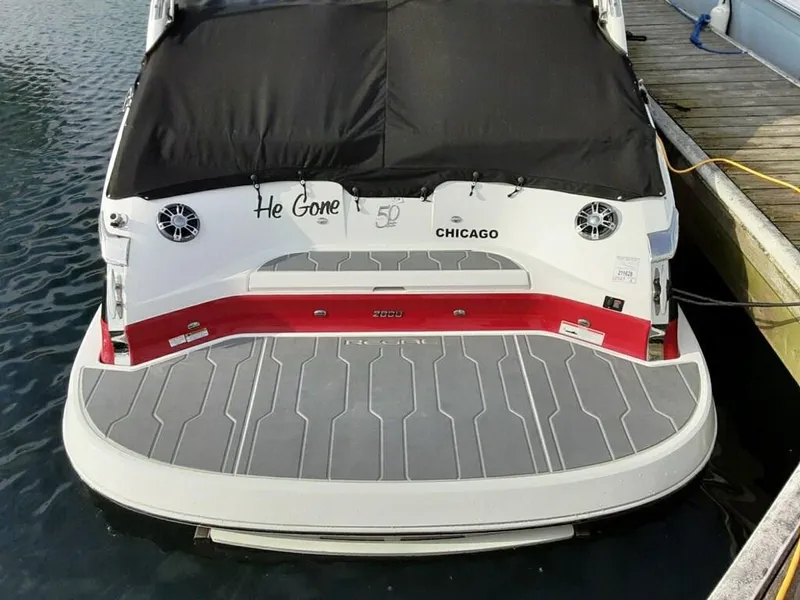 Slide: The Image of 2021 Regal 2800 Bowrider docked, rear view with black cover and red accents. - 5