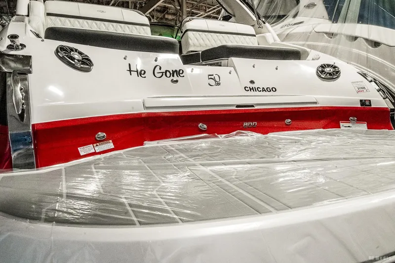 Slide: The Image of 2021 Regal 2800 Bowrider boat with "He Gone" and "Chicago" text on the stern. - 6