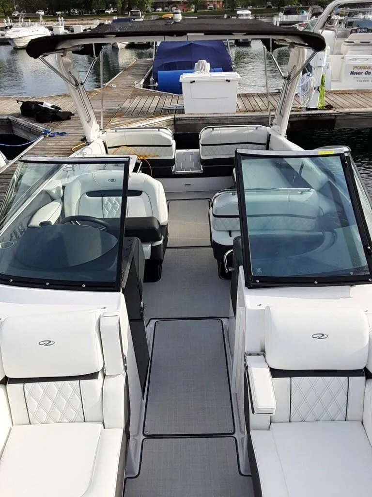 Slide: The Image of 2021 Regal 2800 Bowrider boat interior with seating, docked at marina. - 8