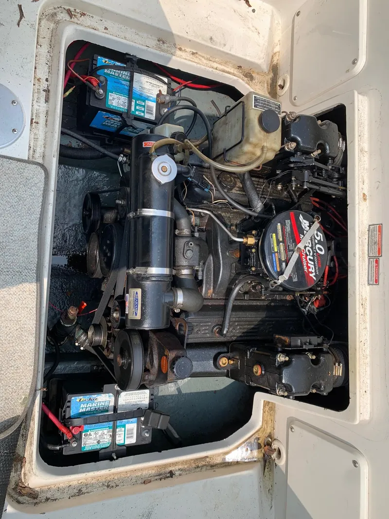 Slide: The Image of Engine compartment of a 2000 Sea Ray 215 Express Cruiser with visible components and batteries. - 7