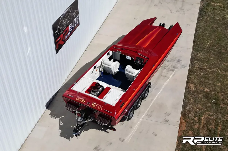 Slide: The Image of 1998 Warlock 28 SXT speedboat, red, parked outside RP Elite Motors & Marine. - 14