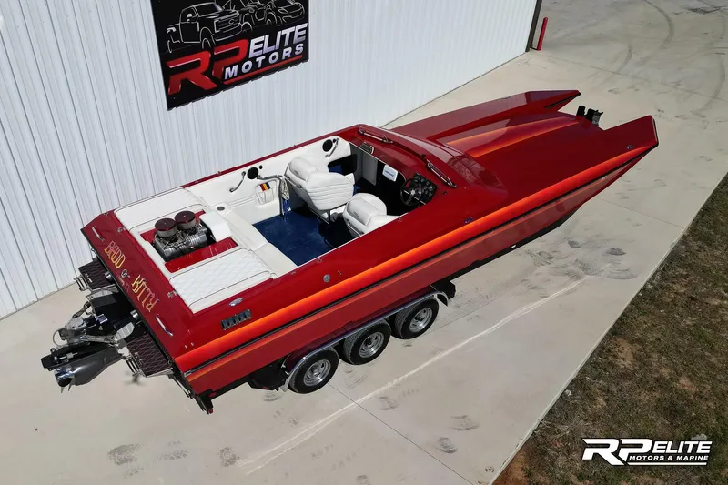 Slide: The Image of 1998 Warlock 28 SXT speedboat in red, parked at RP Elite Motors. - 19