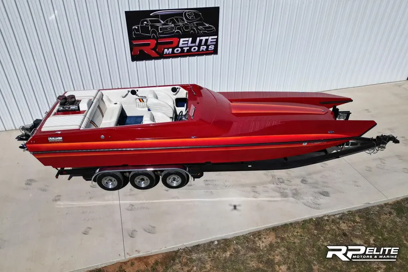Slide: The Image of Red 1998 Warlock 28 SXT boat parked at RP Elite Motors. - 20