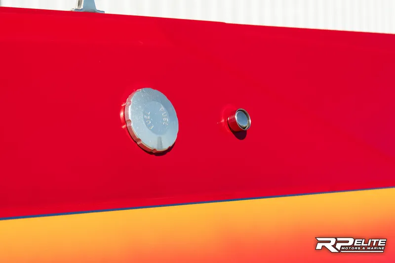 Slide: The Image of Close-up of a 1998 Warlock 28 SXT boat's red and orange exterior with fuel cap. - 24