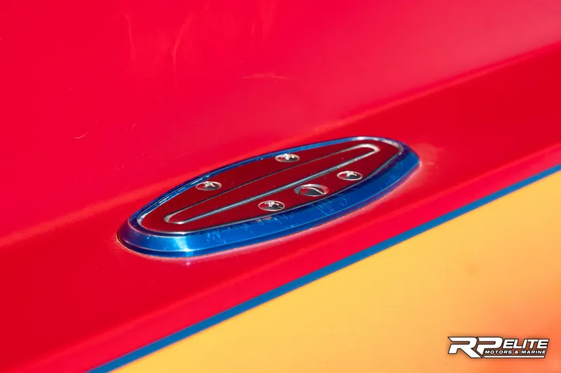Slide: The Image of Close-up of a 1998 Warlock 28 SXT boat detail with vibrant red and yellow colors. - 25