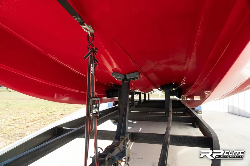 Slide: The Image of Red 1998 Warlock 28 SXT boat on trailer, underside view. - 31