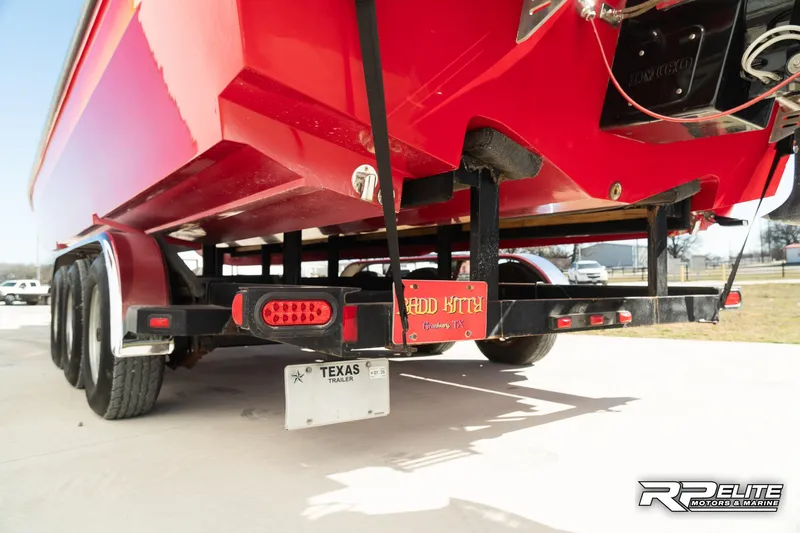Slide: The Image of Red 1998 Warlock 28 SXT boat on trailer, Texas license plate visible. - 37