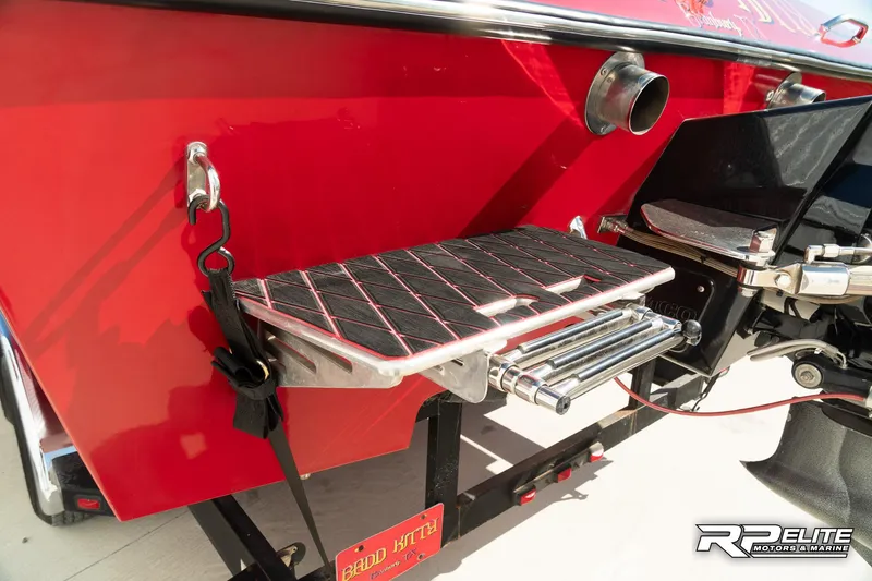 Slide: The Image of 1998 Warlock 28 SXT boat with red hull and swim platform. - 38