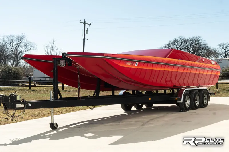 Slide: The Image of Red 1998 Warlock 28 SXT powerboat on trailer, parked outdoors. - 4