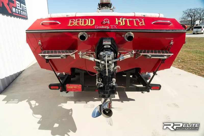 Slide: The Image of Rear view of a 1998 Warlock 28 SXT boat with "Badd Kitty" text. - 41