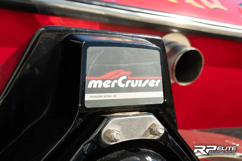 Slide: The Image of MerCruiser engine detail on 1998 Warlock 28 SXT boat, featuring red and black design. - 43