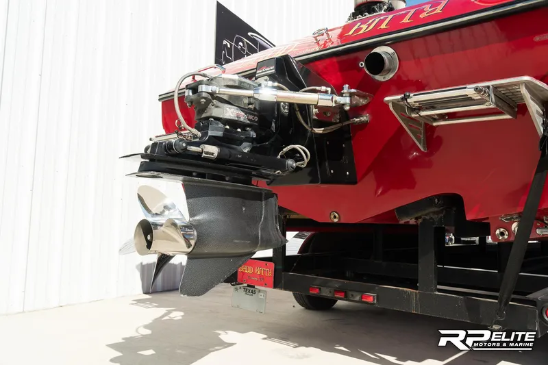 Slide: The Image of 1998 Warlock 28 SXT boat, rear view showing propeller and engine details. - 45