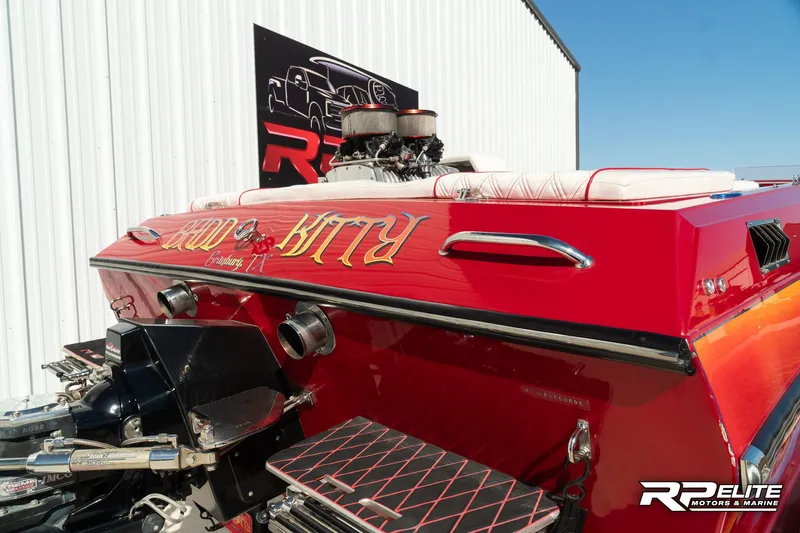 Slide: The Image of 1998 Warlock 28 SXT boat, red exterior, displayed at RP Elite Motors & Marine. - 48
