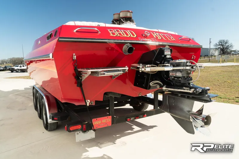 Slide: The Image of Red 1998 Warlock 28 SXT speedboat on trailer, rear view, sunny day. - 6