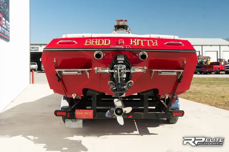 Slide: The Image of Red 1998 Warlock 28 SXT boat, rear view, on trailer, labeled "Badd Kitty." - 7