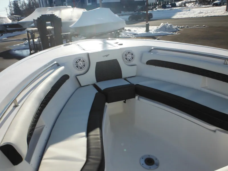 Slide: The Image of 2025 Tidewater 232 LXF boat interior with cushioned seating and speakers, parked in snowy area. - 10