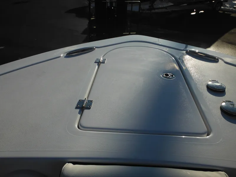 Slide: The Image of Bow deck of 2025 Tidewater 232 LXF boat, featuring storage hatch and sleek design. - 11
