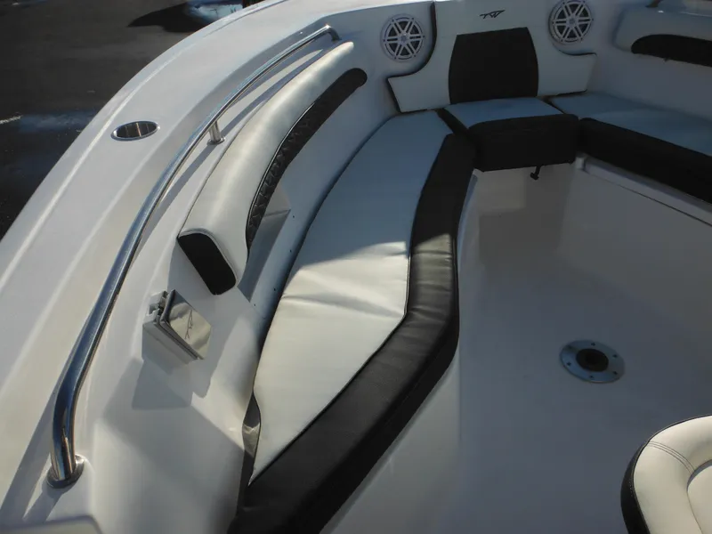 Slide: The Image of 2025 Tidewater 232 LXF boat interior with cushioned seating and stainless steel railings. - 13
