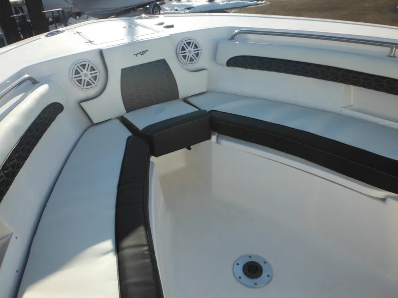 Slide: The Image of 2025 Tidewater 232 LXF boat interior with cushioned seating and speakers. - 14