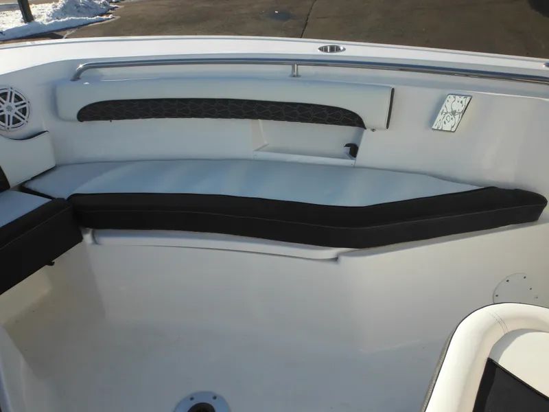 Slide: The Image of 2025 Tidewater 232 LXF boat interior seating with black and white cushions. - 15