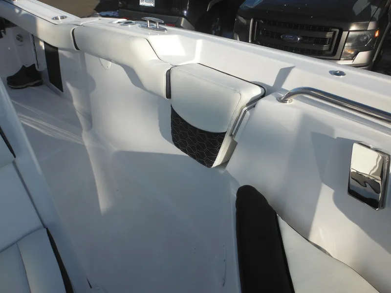 Slide: The Image of 2025 Tidewater 232 LXF boat interior with sleek seating and storage features. - 17