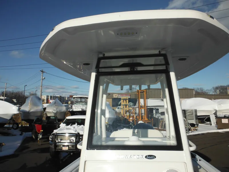Slide: The Image of 2025 Tidewater 232 LXF boat with T-top, parked outdoors in a snowy setting. - 19