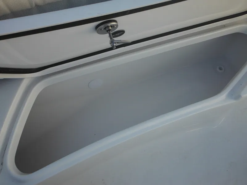 Slide: The Image of Storage compartment of 2025 Tidewater 232 LXF boat, open and empty. - 20
