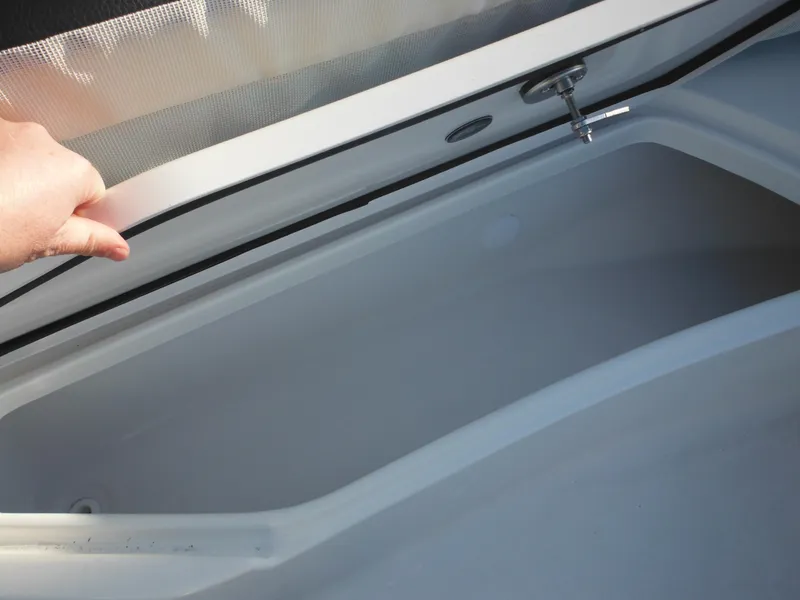 Slide: The Image of Open storage compartment of 2025 Tidewater 232 LXF boat. - 21