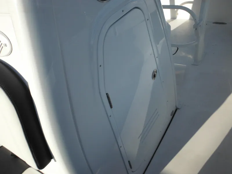 Slide: The Image of 2025 Tidewater 232 LXF boat interior, featuring a sleek white storage compartment. - 23