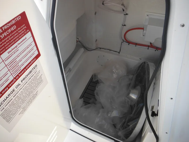 Slide: The Image of Storage compartment of 2025 Tidewater 232 LXF boat, featuring safety instructions and equipment. - 24