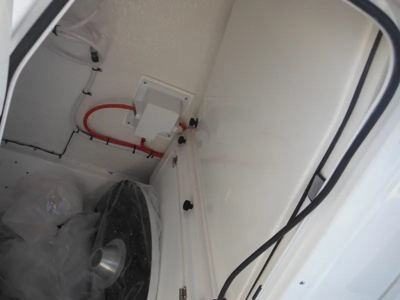 Slide: The Image of Interior compartment of 2025 Tidewater 232 LXF boat, showing wiring and storage space. - 25