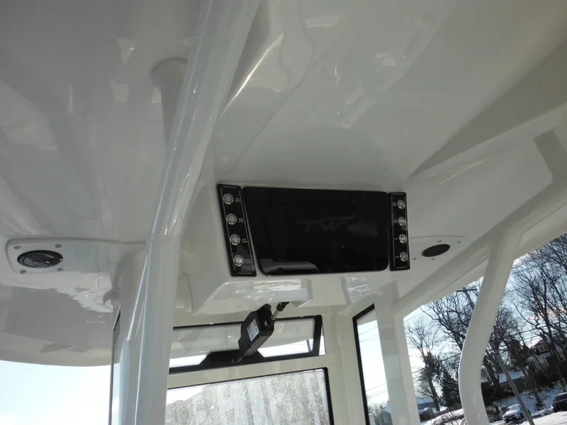 Slide: The Image of 2025 Tidewater 232 LXF boat interior with modern electronics and sleek design. - 26