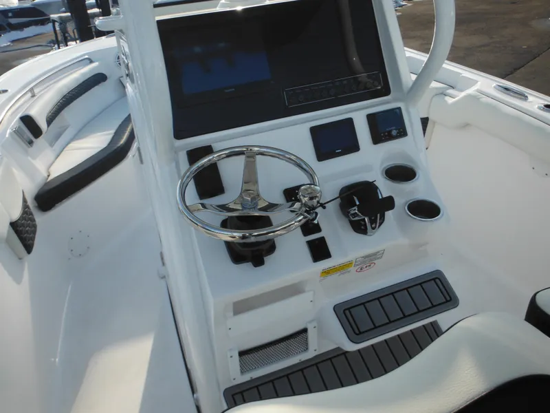 Slide: The Image of 2025 Tidewater 232 LXF boat console with steering wheel and controls. - 27