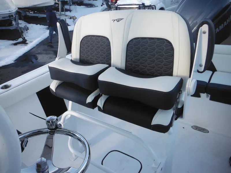 Slide: The Image of 2025 Tidewater 232 LXF boat seats with black and white upholstery. - 29